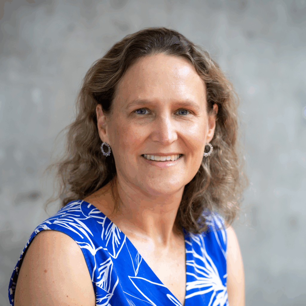 Professional headshot of Professor Anne Cust smiling at the camera