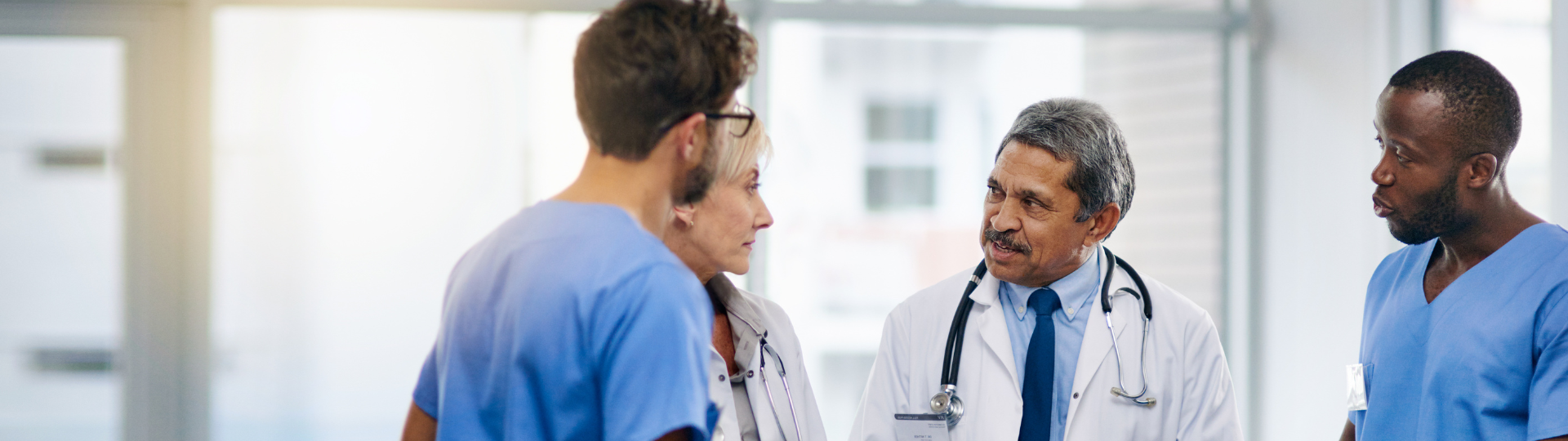 Group of four medical professionals in discussion